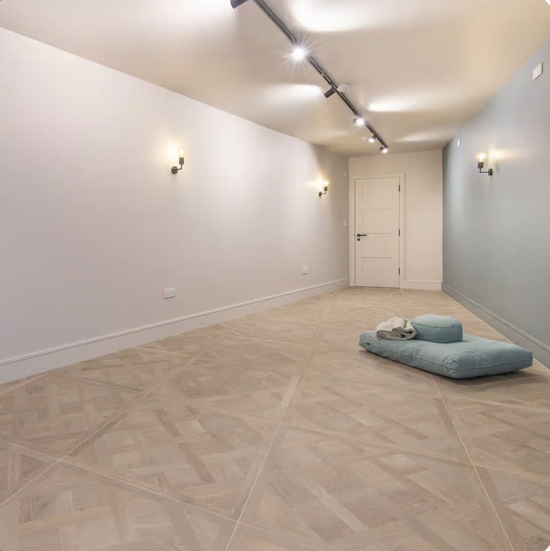 A calm breathwork room with a floor cushion and soft lighting